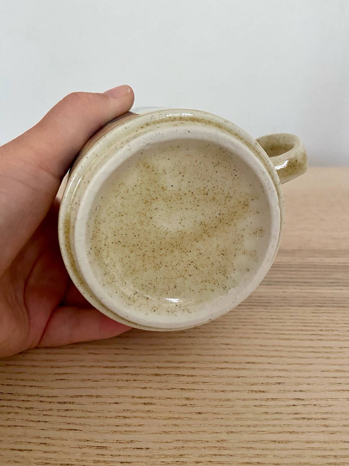 Speckled stoneware cup with blue flower