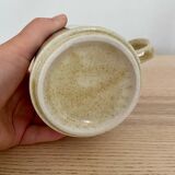 Speckled stoneware cup with blue flower