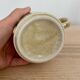 Speckled stoneware cup with blue flower