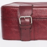 Red faux leather suitcase