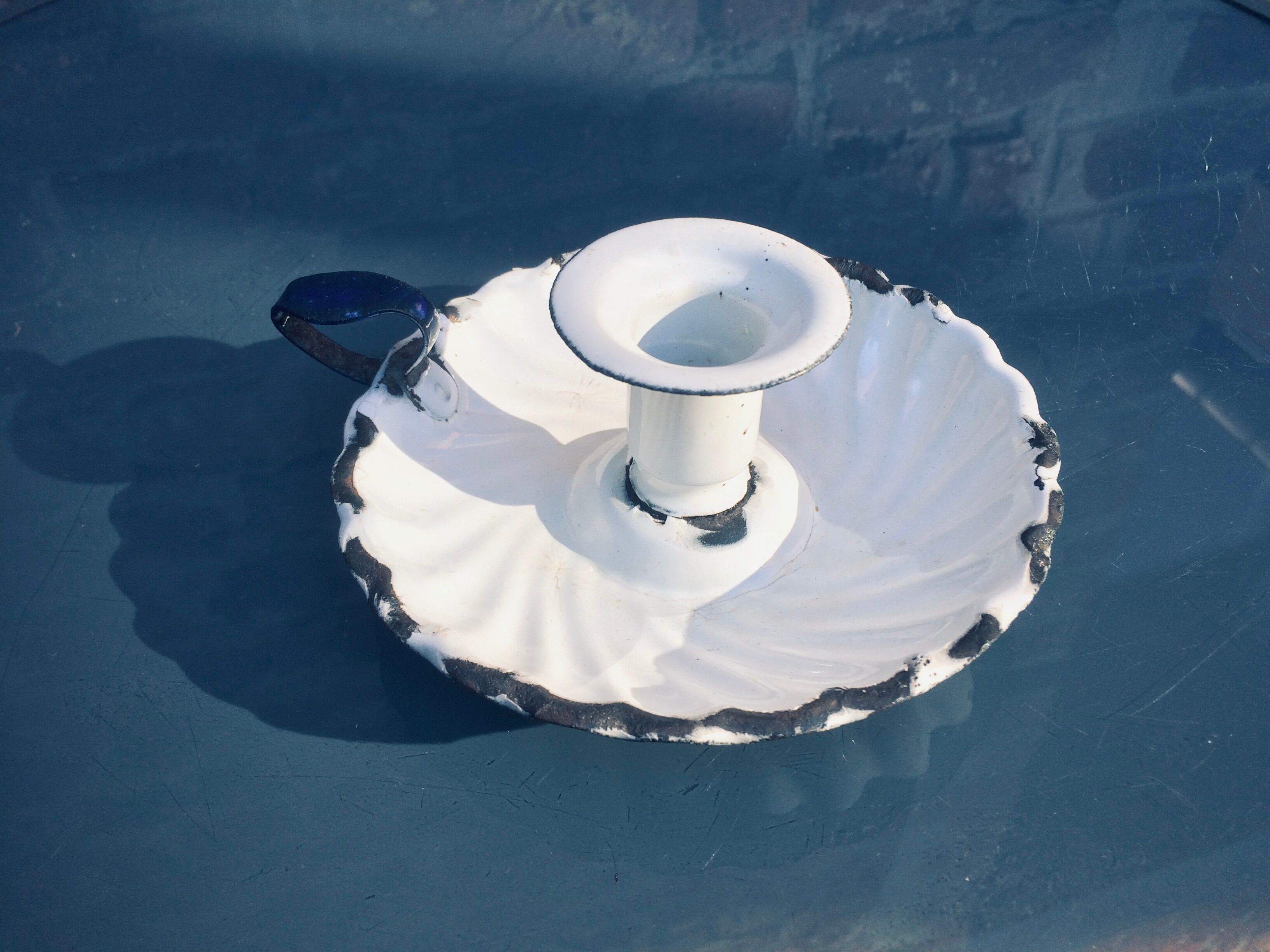 Old white enamelled candlestick