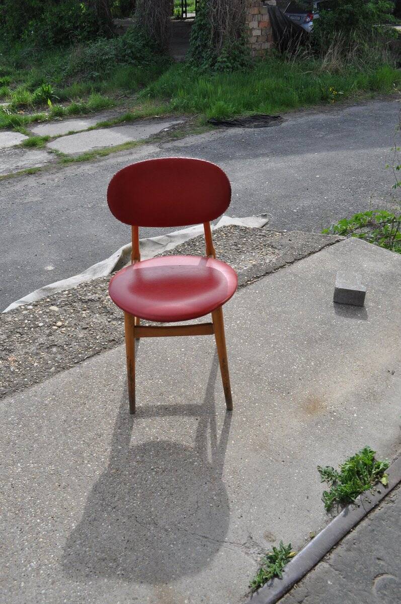 Vintage red office chair in faux leather and wood, 1960s Central European style.