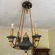 Empire style chandelier with four lights in sheet metal, bronze with patina and gilding