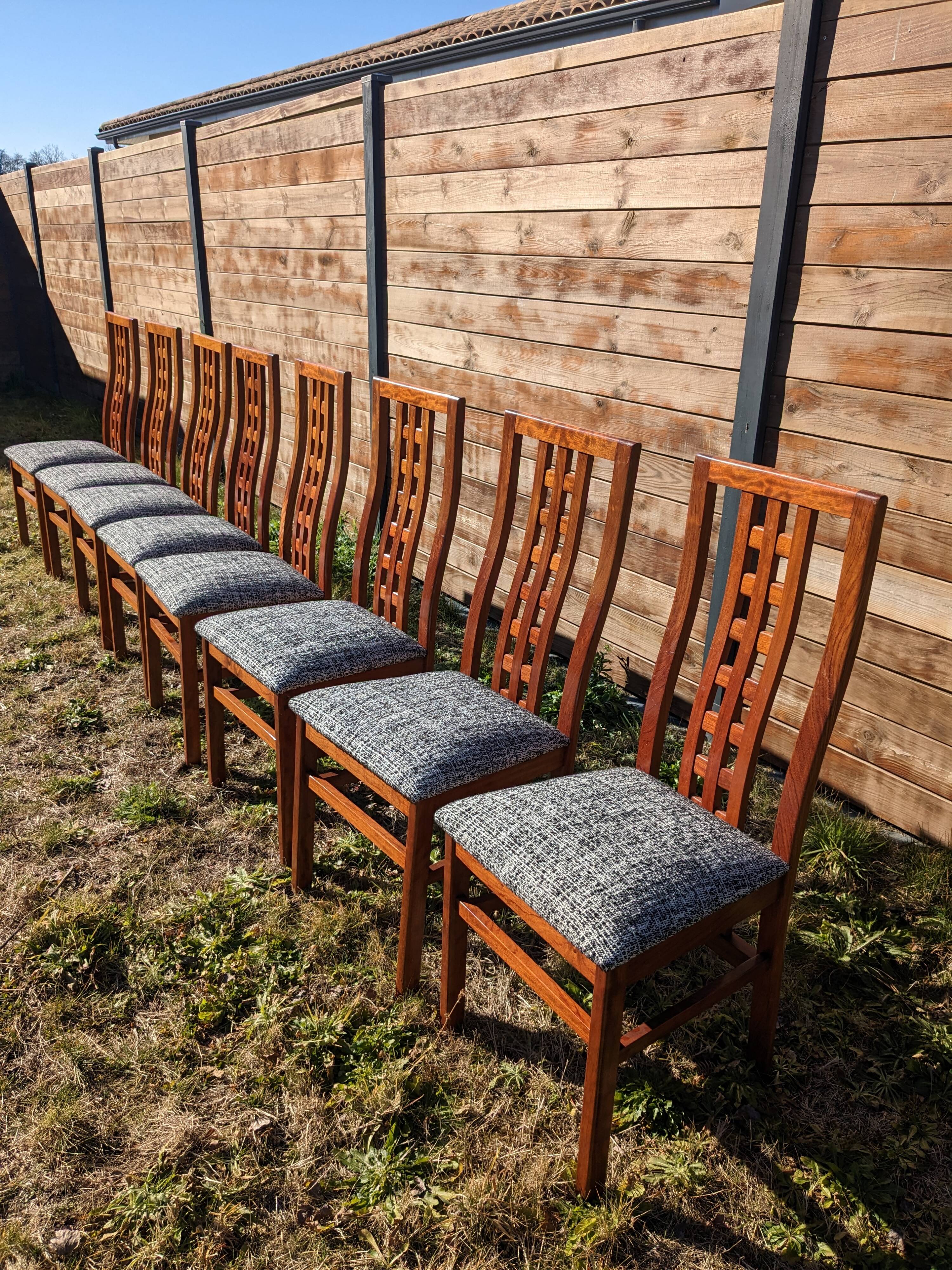 Set of 8 teak lounge chairs with high backs and zebra-striped seats