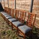 Set of 8 teak lounge chairs with high backs and zebra-striped seats