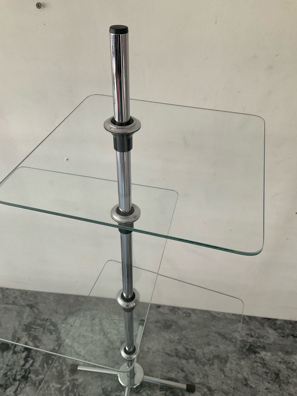 A pair of vintage side tables in glass and chrome metal.