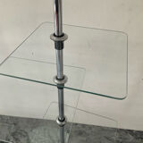 A pair of vintage side tables in glass and chrome metal.