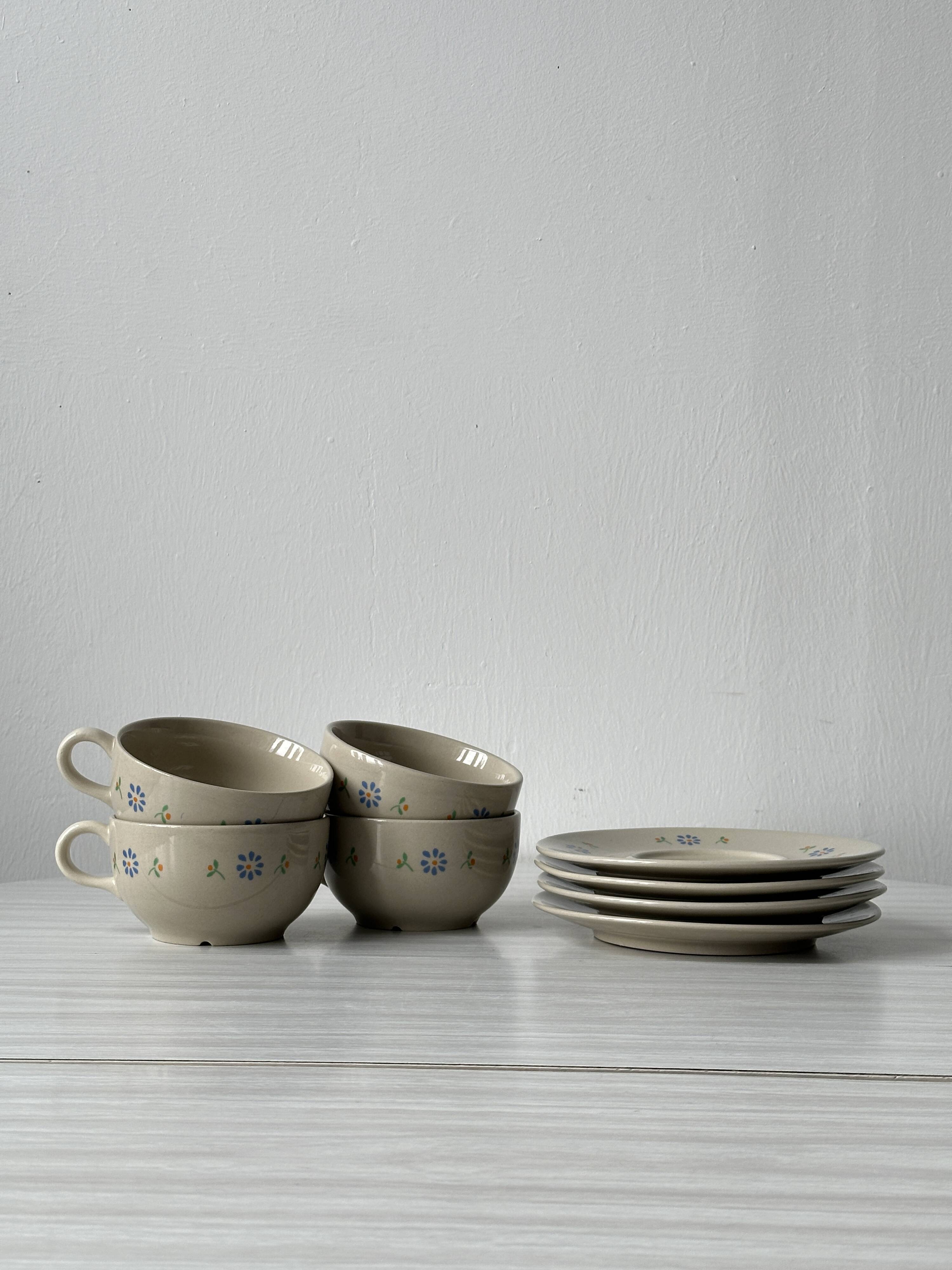 Ceramic cups and saucers with flower decoration