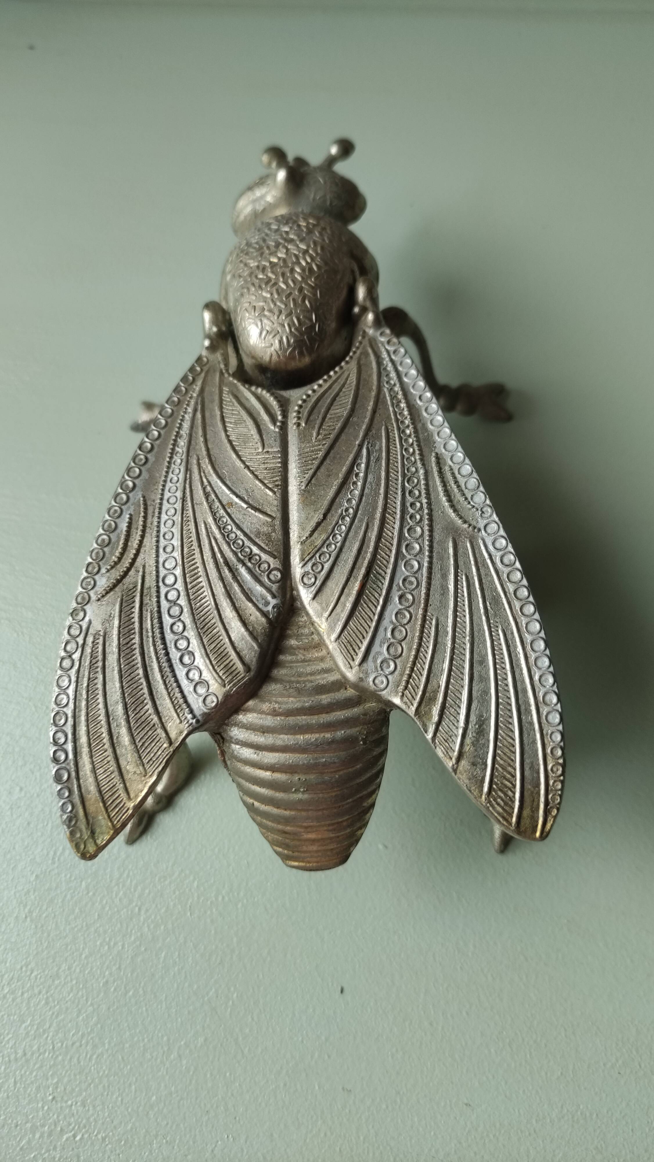 Vintage metal fly, old ashtray to divert