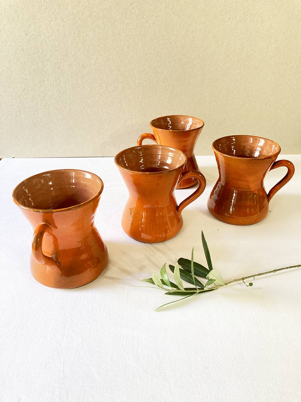 4 large orange enameled ceramic cups, signed