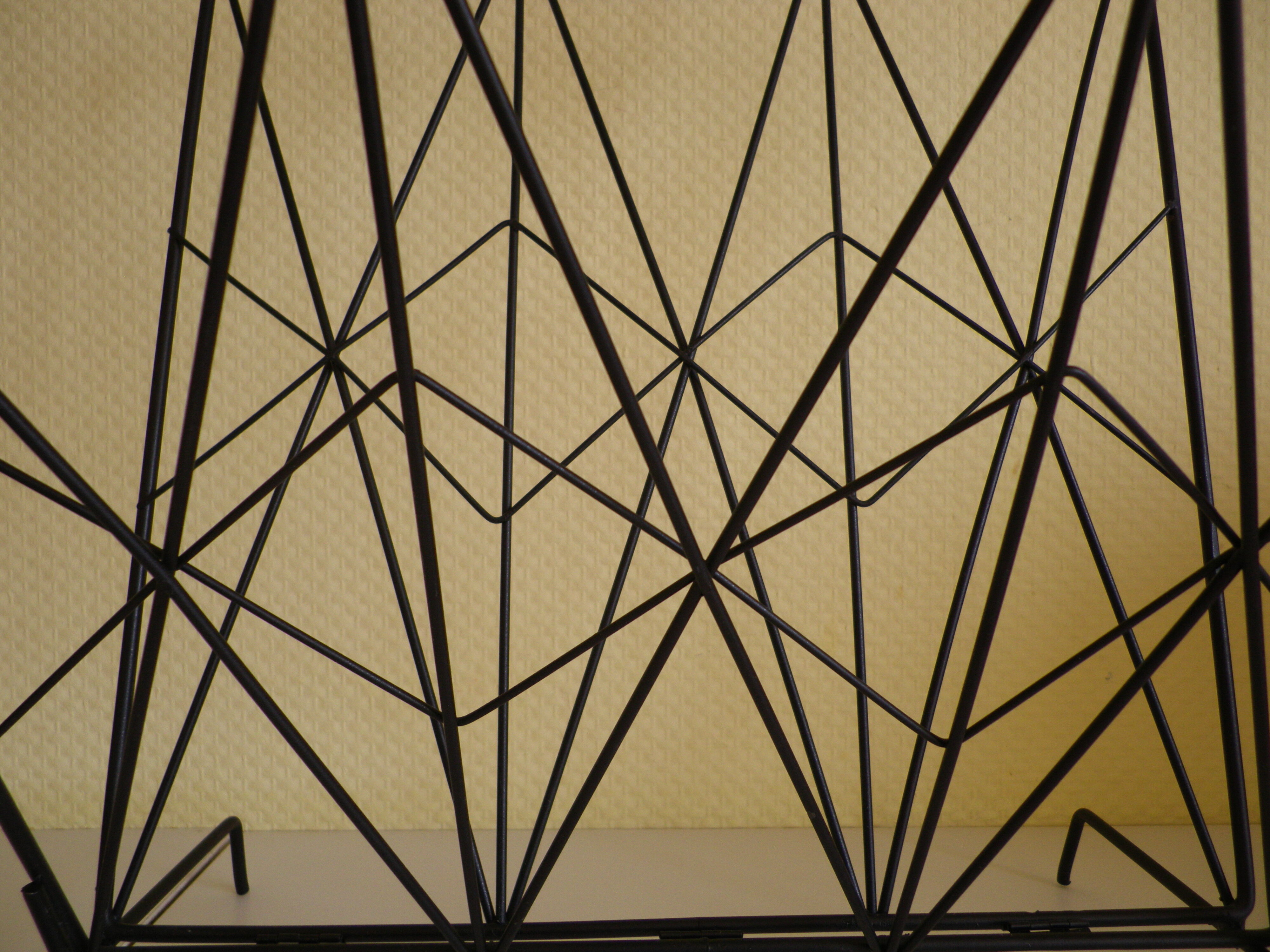 Magazines rack with very fine black metal geometric