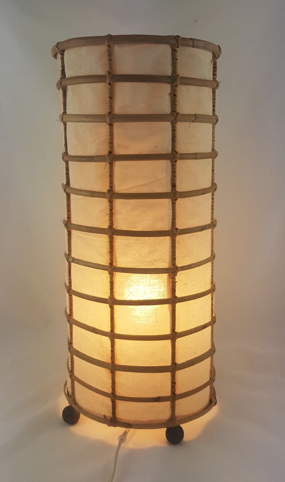 Lamp to be laid in rattan and fabric