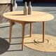 Large round family table with 2 extensions in solid raw wood.
