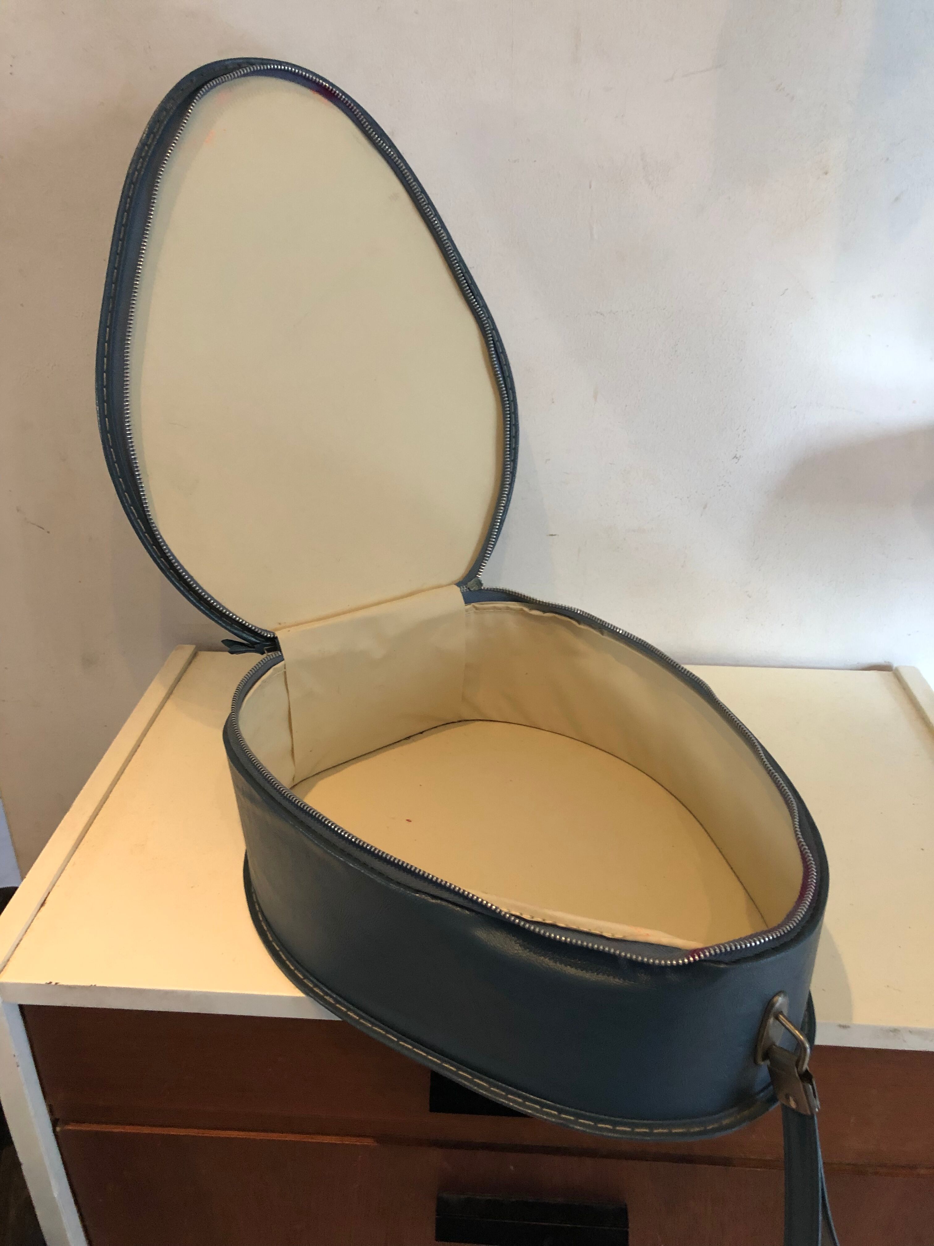 Suitcase has an air hostess hat