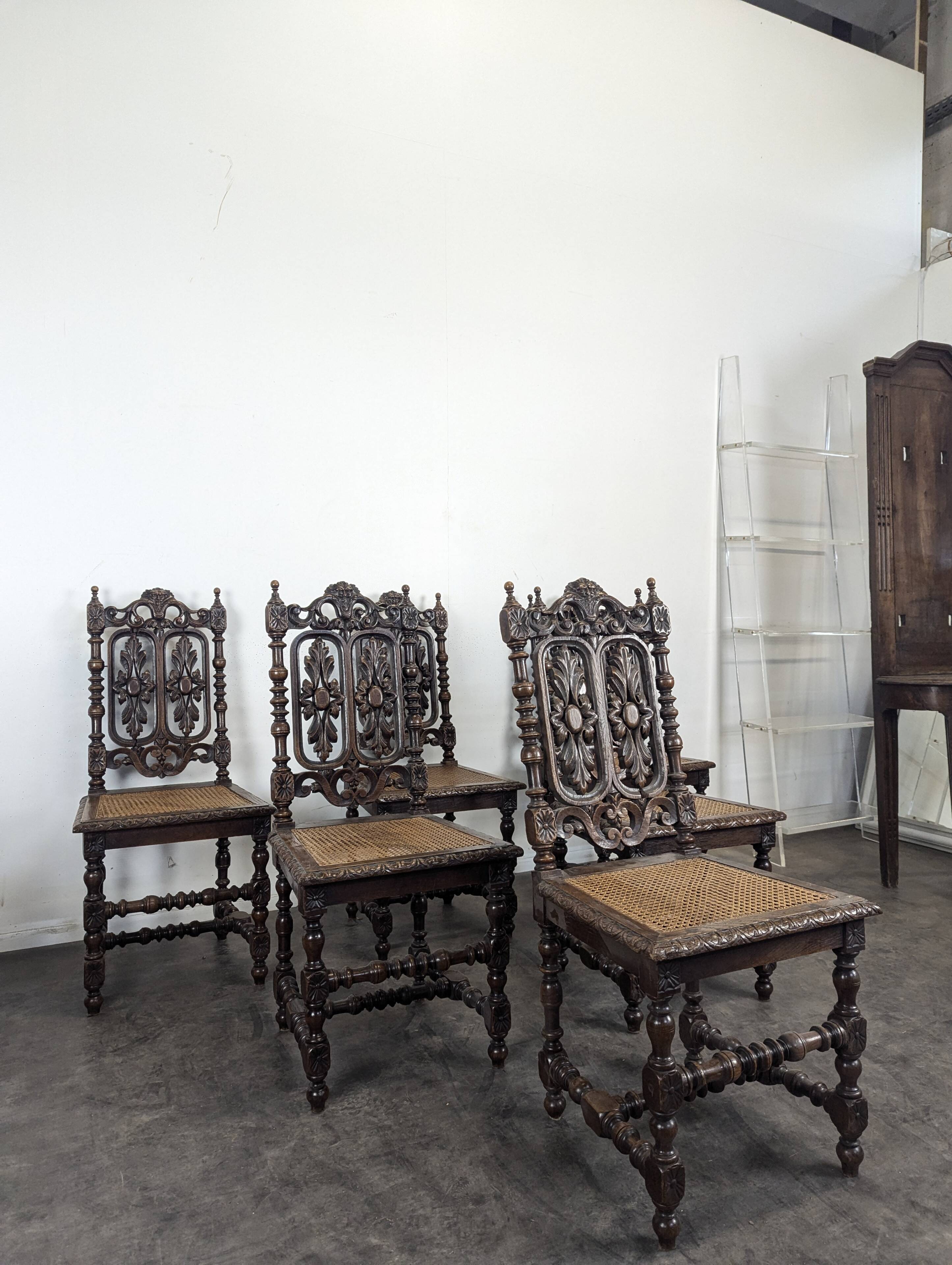 Set of 6 Henri II chairs in carved openwork oak with caned seats.