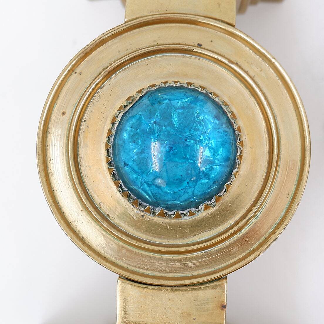 Pair of brass candlesticks decorated with a blue stone inlaid in the center