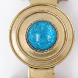 Pair of brass candlesticks decorated with a blue stone inlaid in the center