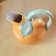 Orange pitcher in slip