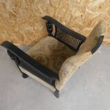 Old armchair upholstered in velvet, carved and caned wood