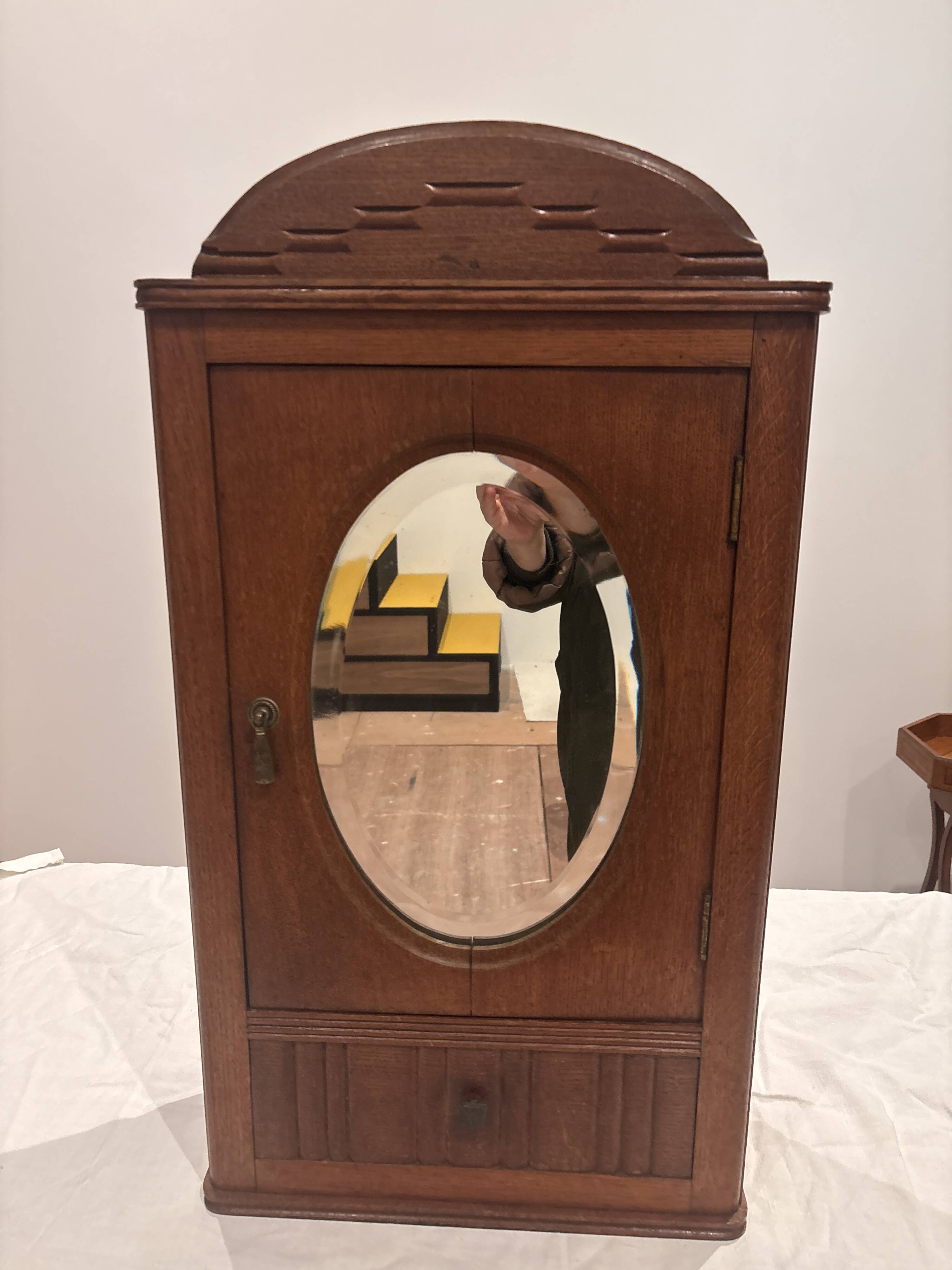 Wall cabinet with oval wall and drawer