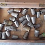 Wooden box containing 30 antique thimbles