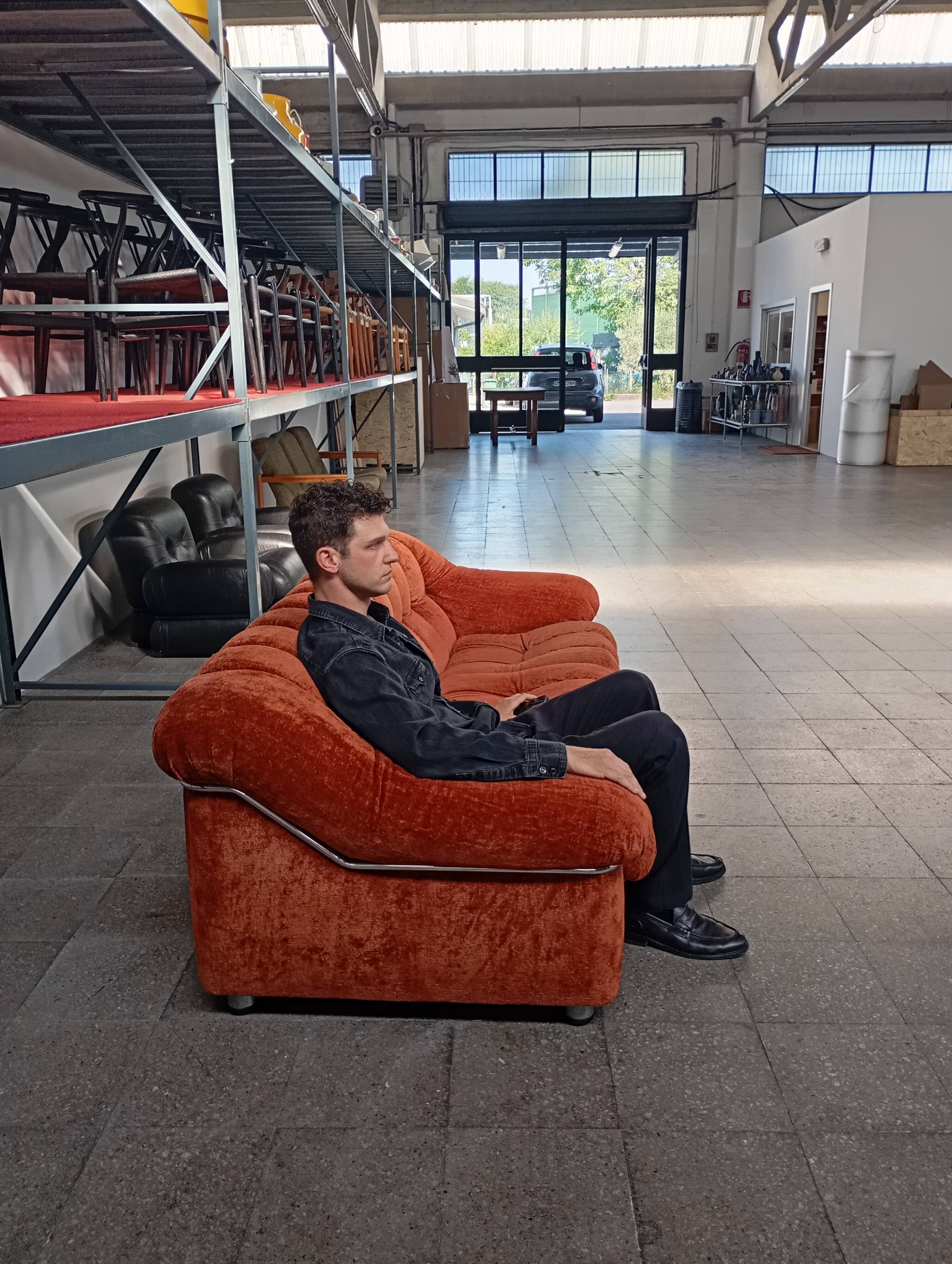 Vintage rust velvet sofa from the 1970s with metal details.
