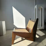 Reclined armchair in canned teak in natural wood