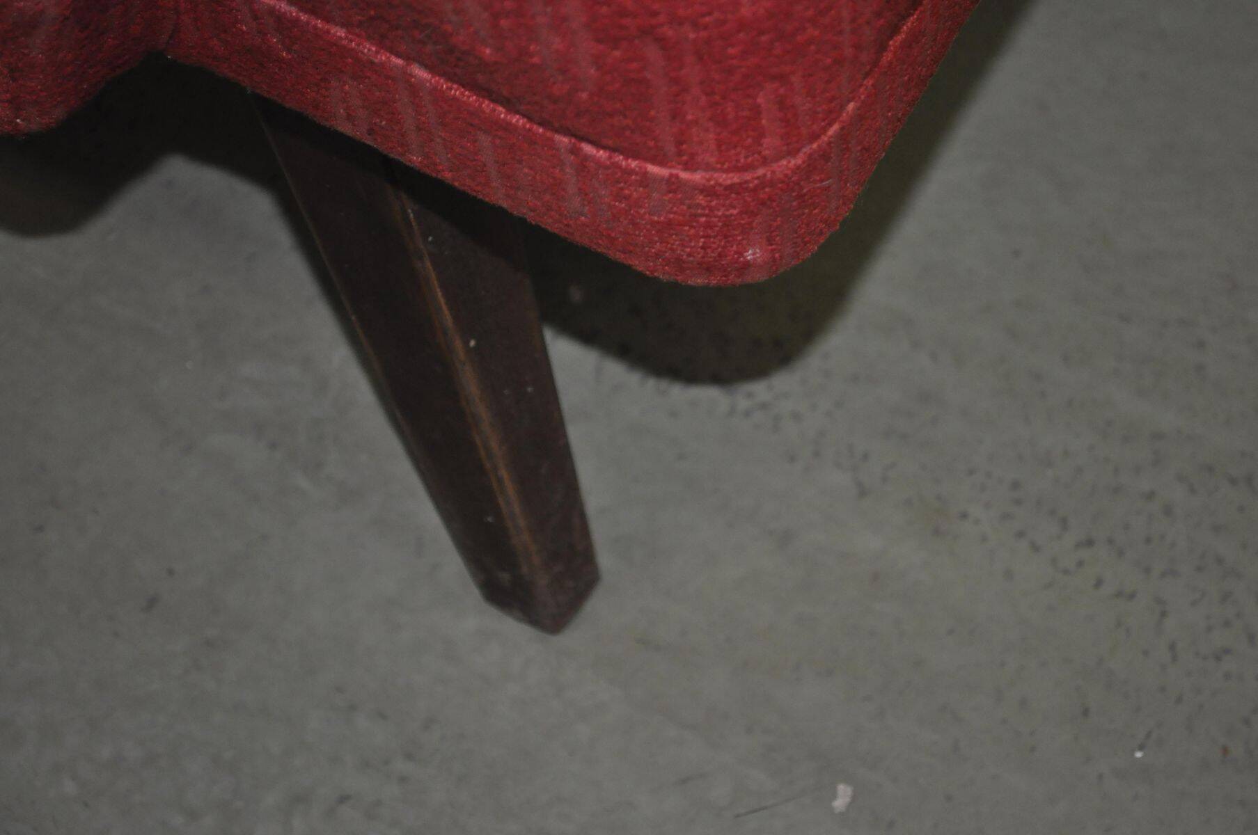 Pair of Mid-Century armchairs in red and brown fabric with dark wooden legs.