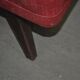 Pair of Mid-Century armchairs in red and brown fabric with dark wooden legs.