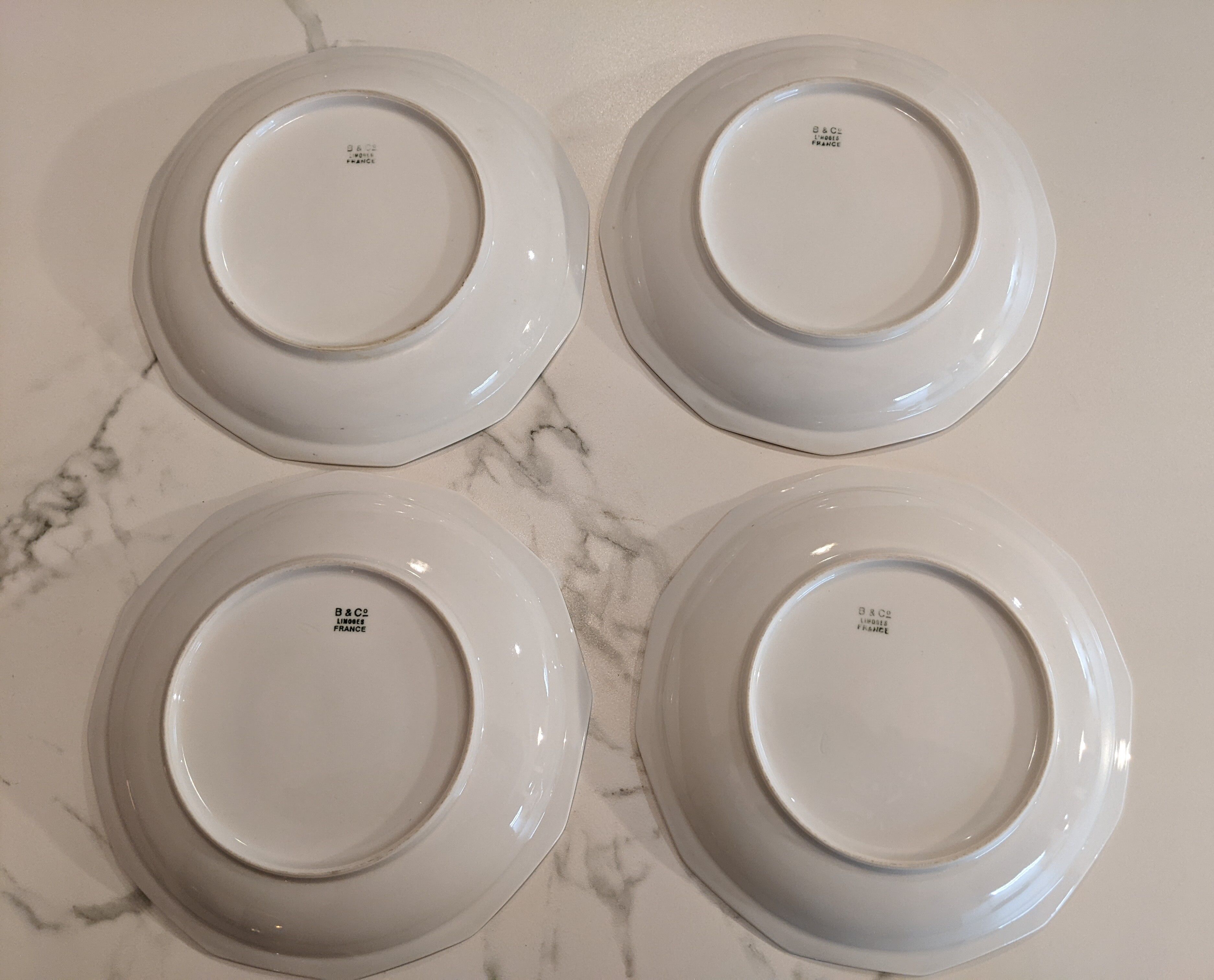 Set of vintage hollow plates in white and gilded Limoges porcelain
