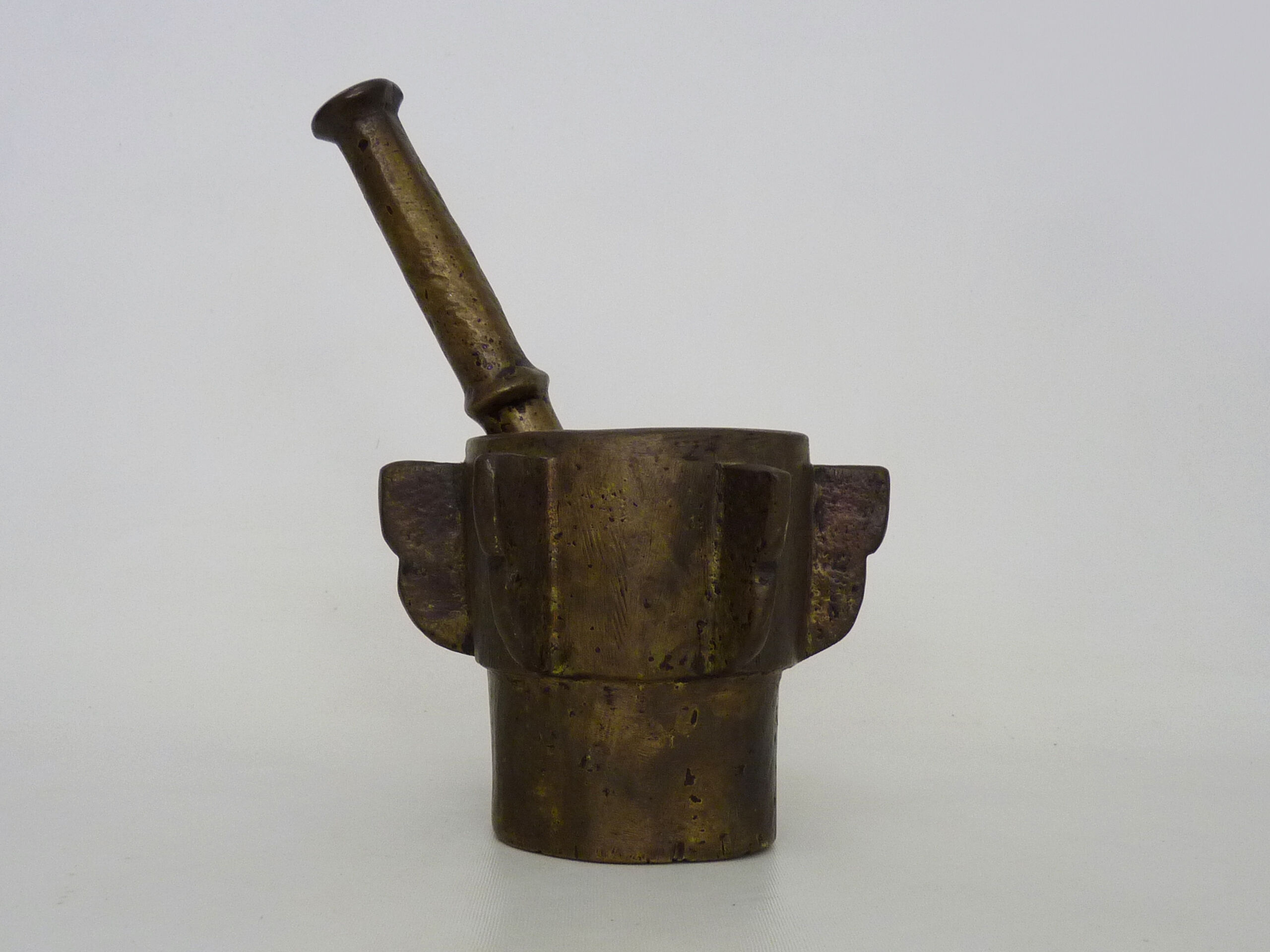 Old apothecary mortar with fins and its bronze pestle