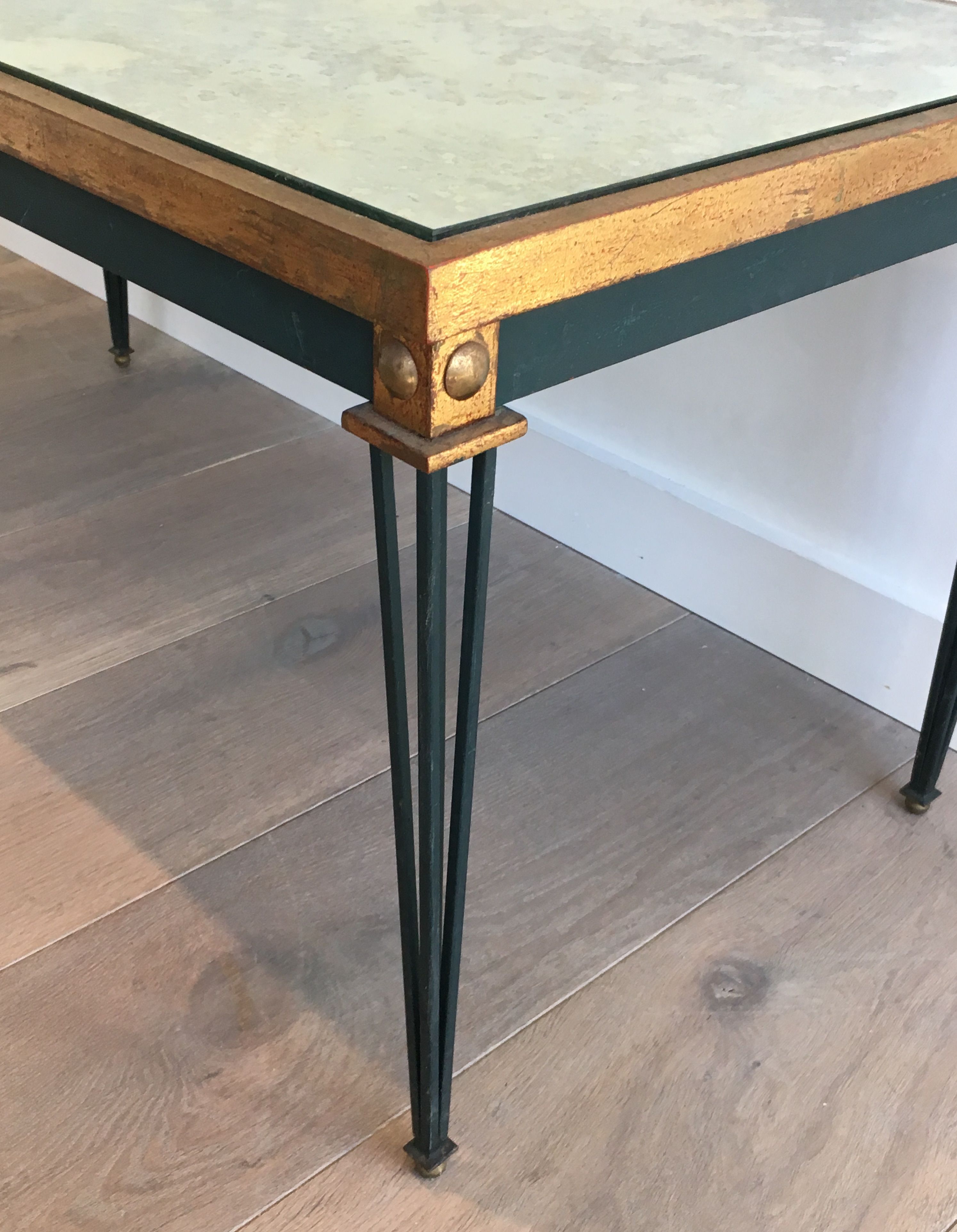 Patinated and gilded steel coffee table in the style of Jacques Quinet.