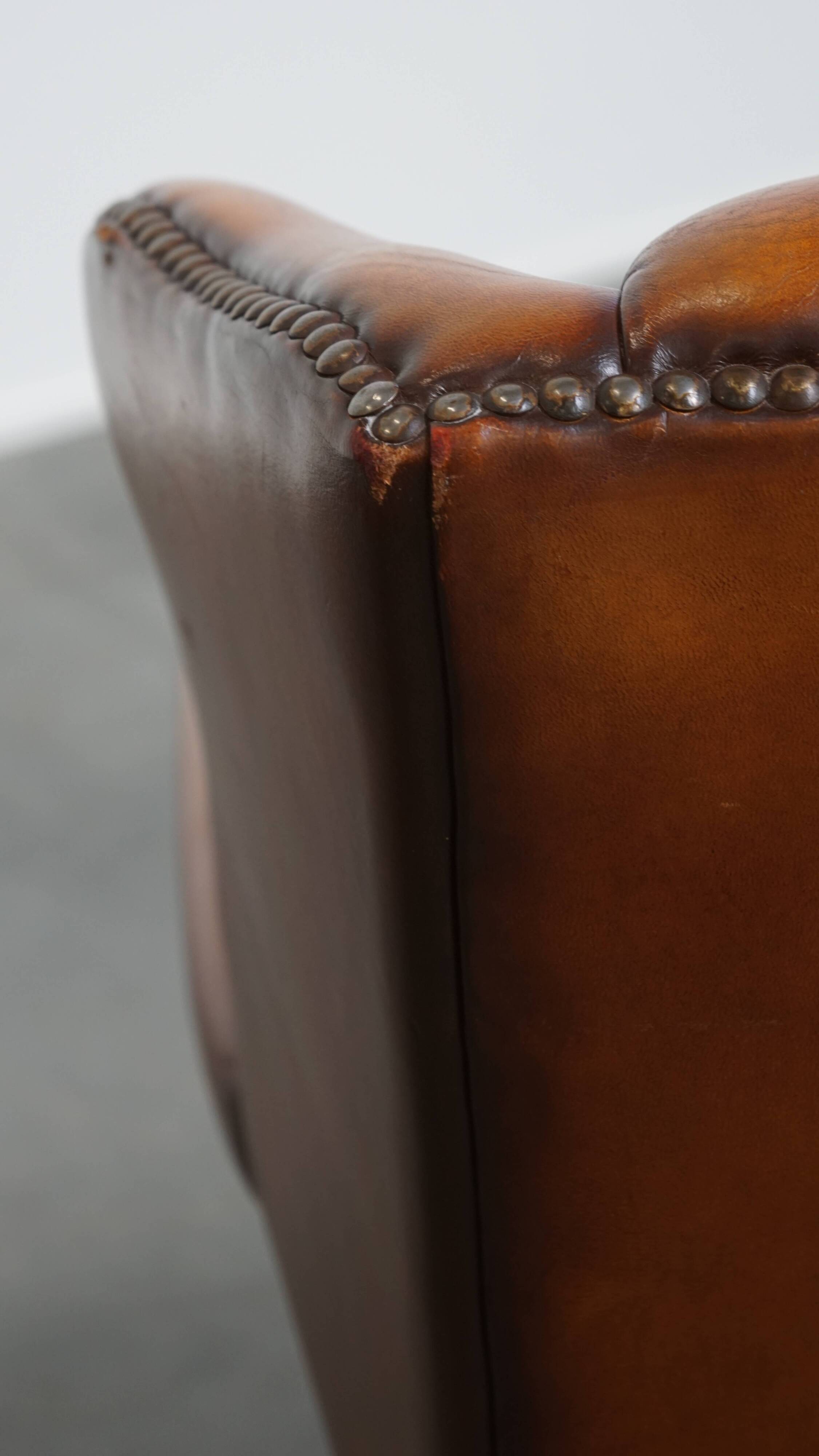 Fauteuil à oreilles en cuir de mouton
