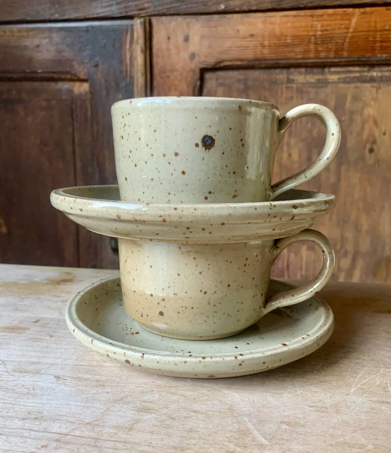 Two large Jean Austruy stoneware cups and saucers