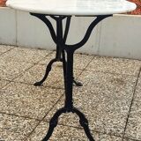White and black oval marble table, wrought iron base