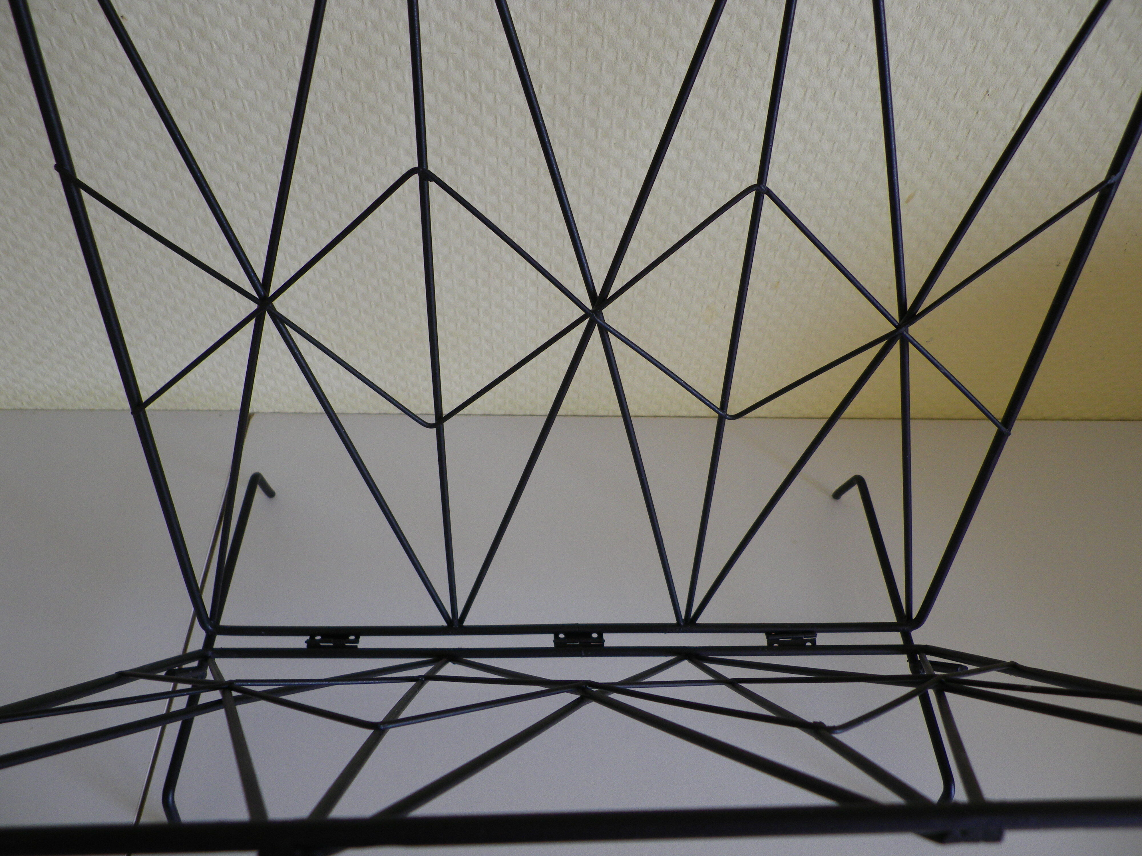 Magazines rack with very fine black metal geometric