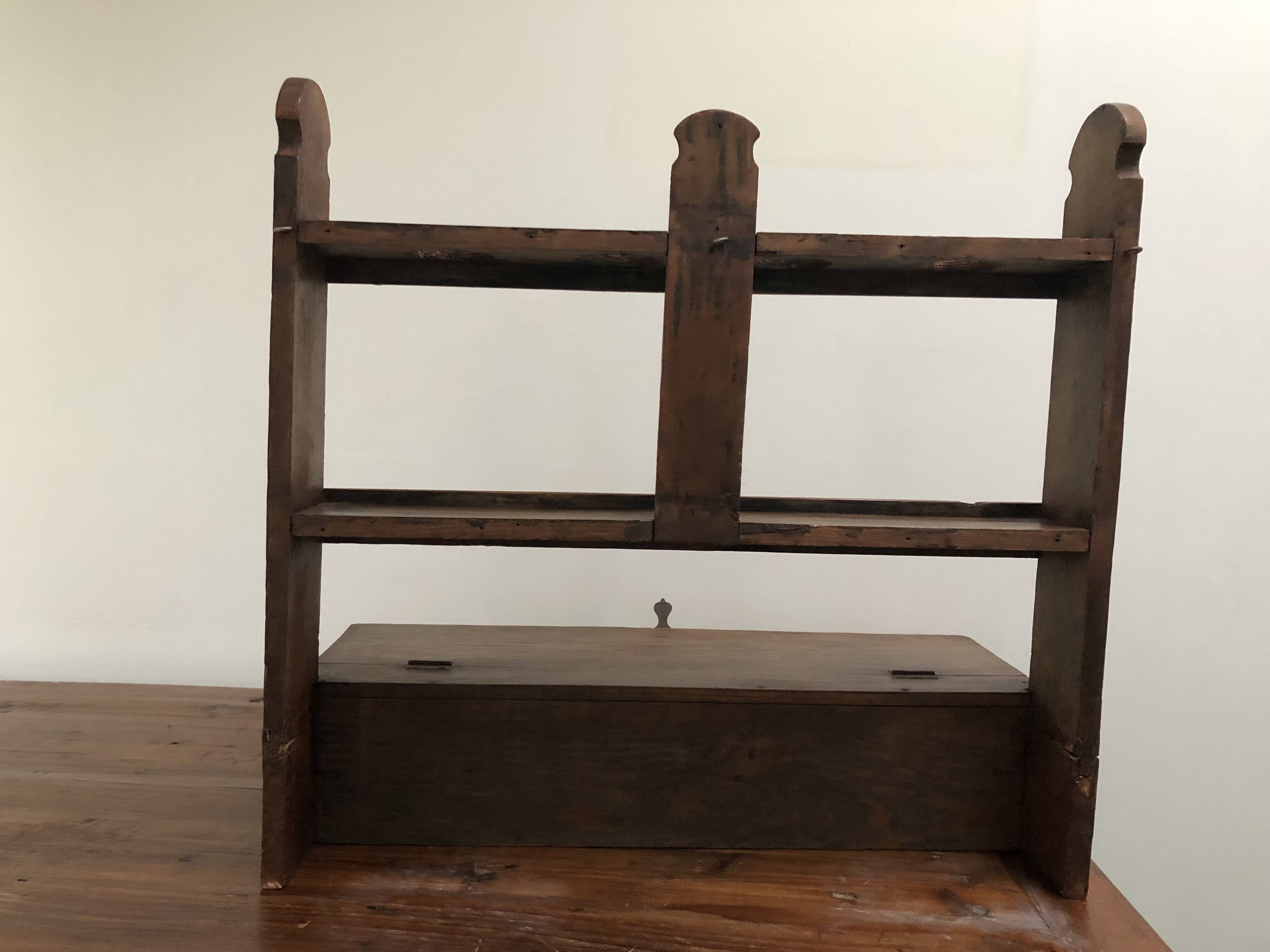 Antique wooden wall shelf that belonged to a religious figure