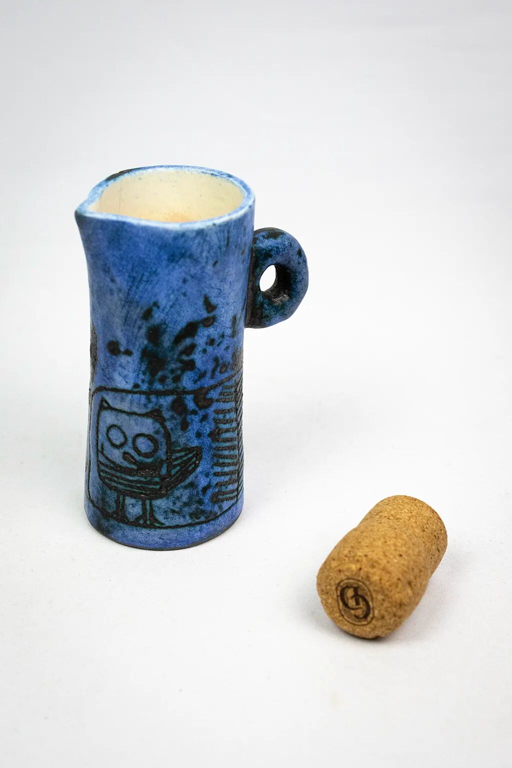 Small jug by Jacques Blin in blue ceramic with engraved animal decoration.