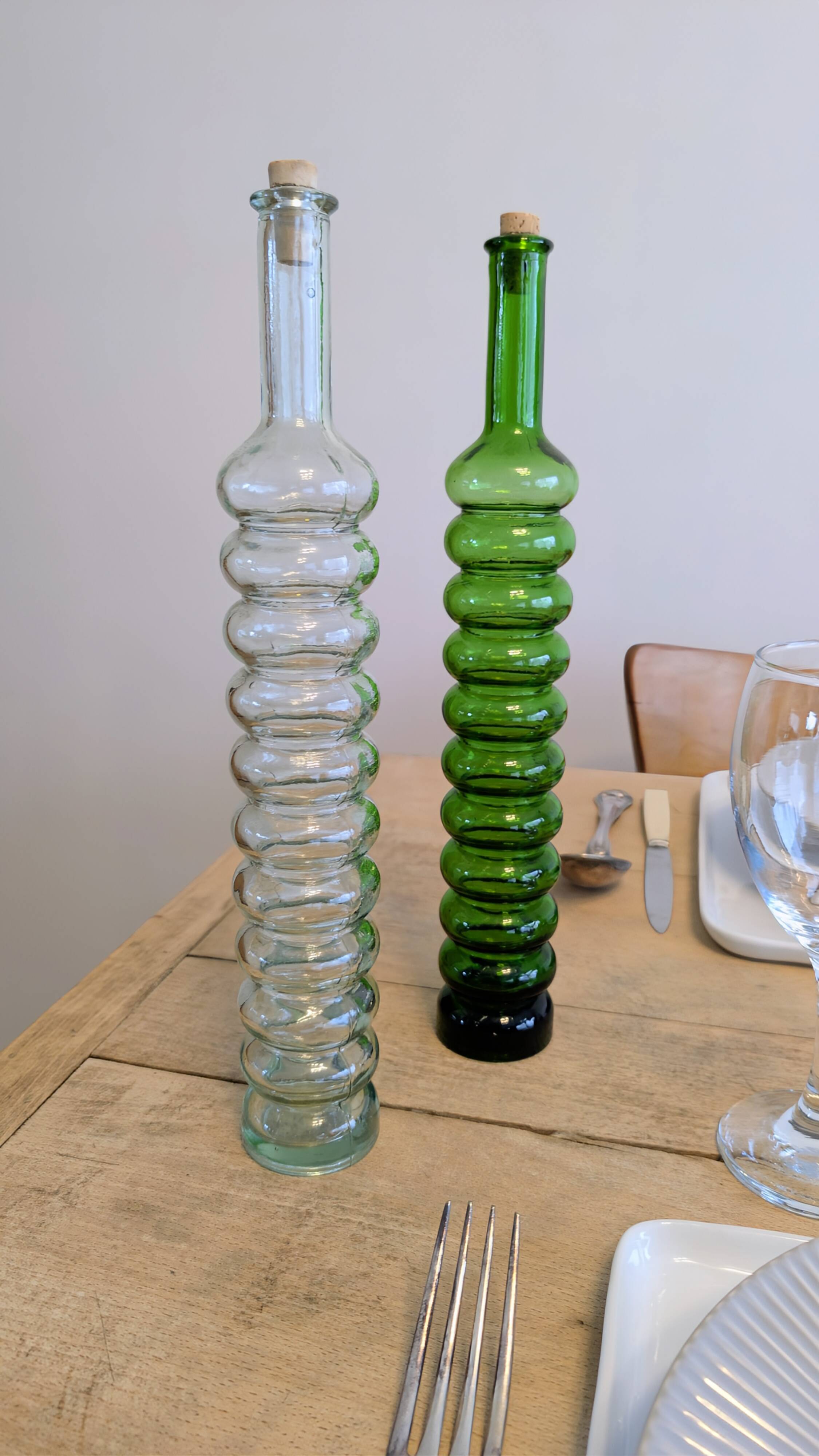 Pair of vintage ribbed blown glass bottles with cork stoppers.