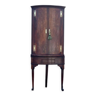 Antique English corner cabinet with a quarter curved front