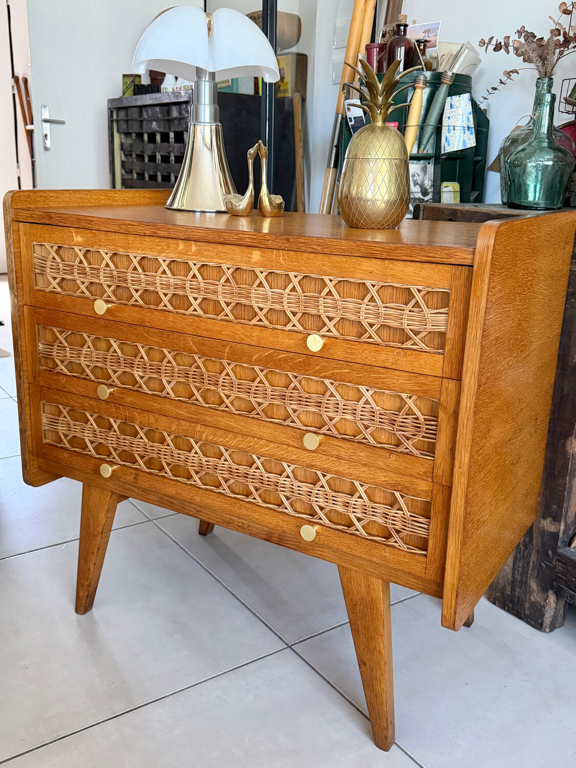 Vintage wooden and rattan chest of drawers with tapered legs.