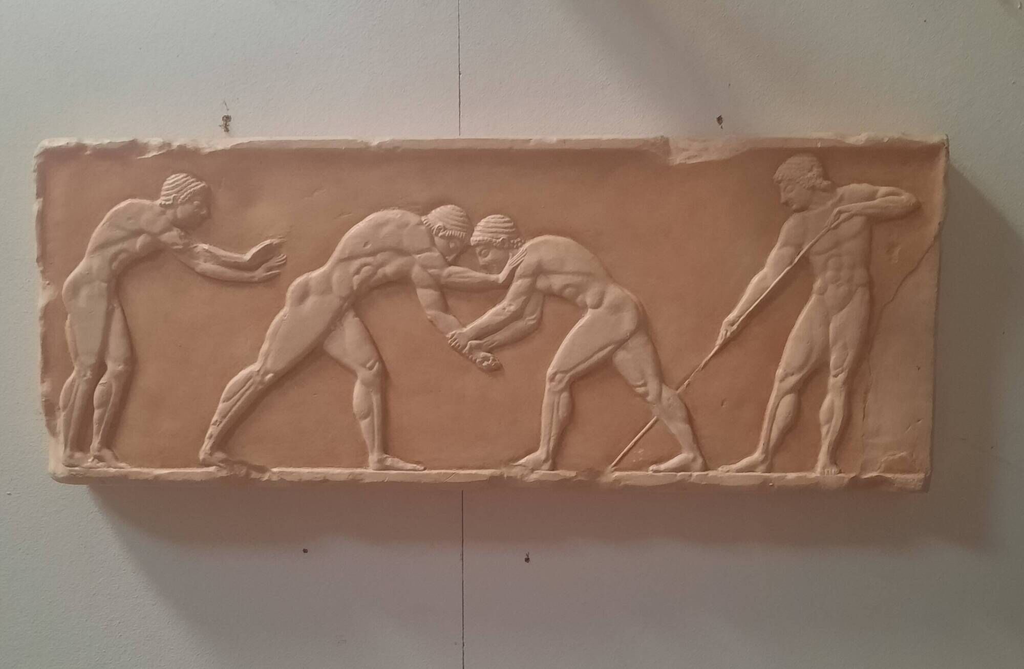 Bas-relief in the antique style featuring athletes.