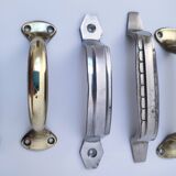 Seven art deco silver tone and brass handles