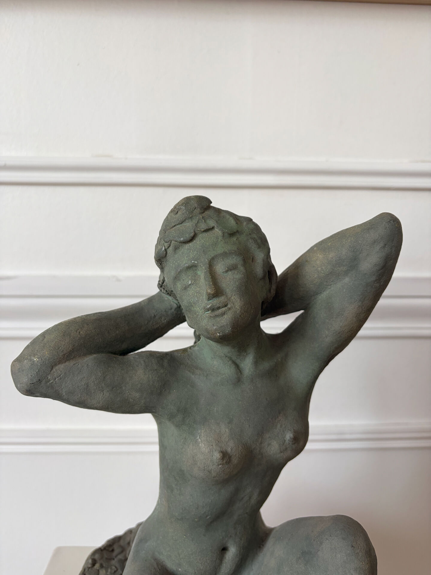 Sculpture of a naked woman titled "Youth" in terracotta.
