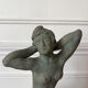 Sculpture of a naked woman titled "Youth" in terracotta.