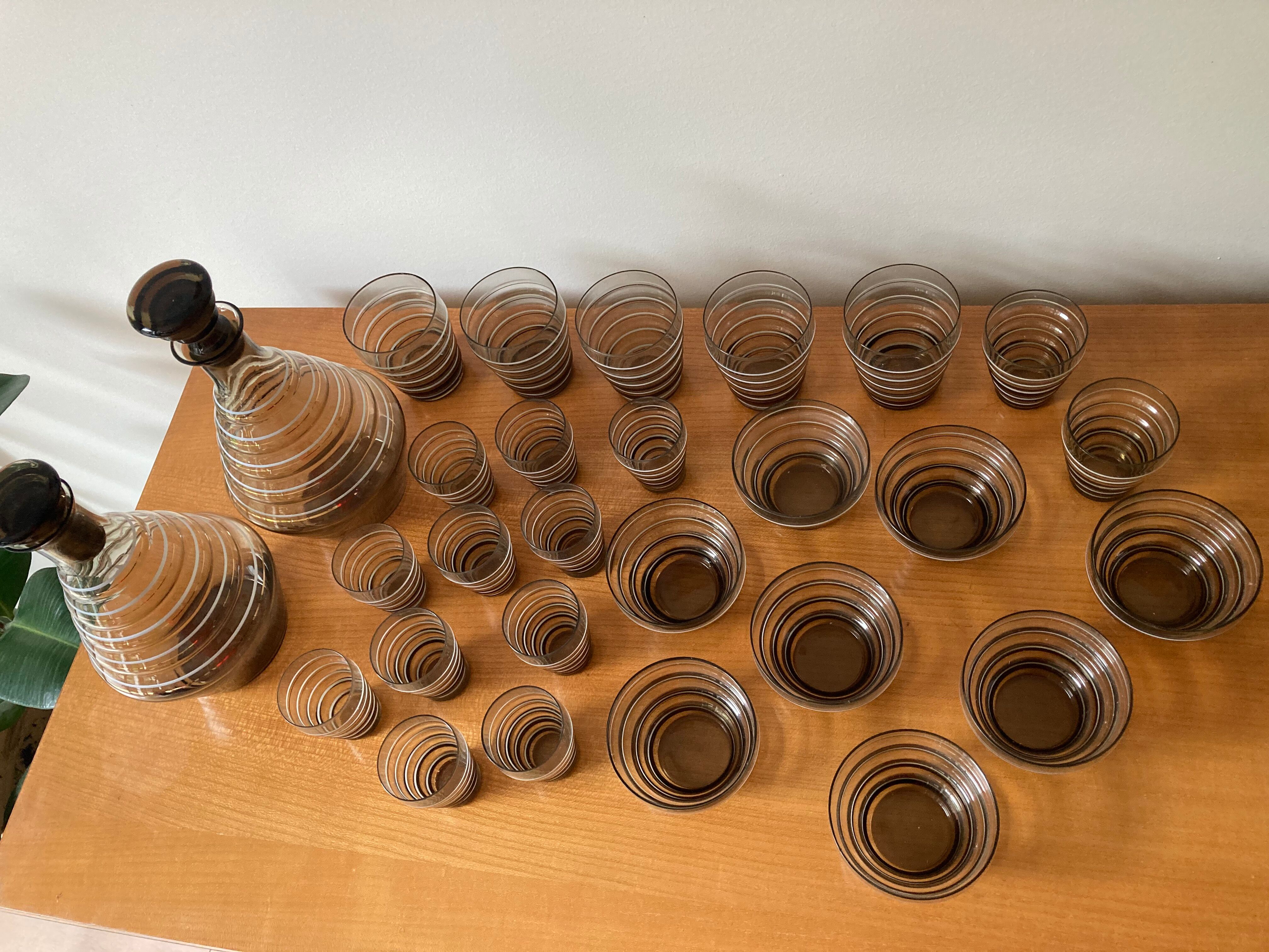 Service of glasses, cups, decanters of the 50s in smoked glass