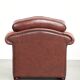 Cowhide chesterfield armchair in a warm brown colour with decorative nails