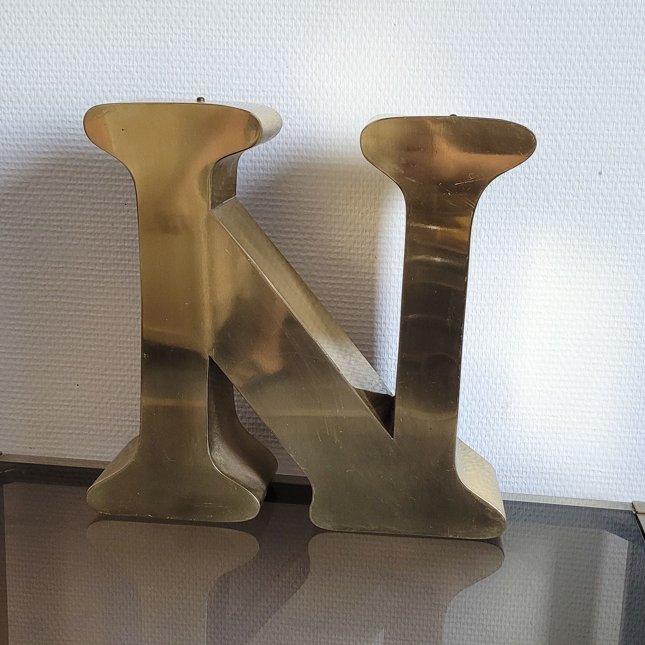 Old letter N of gilded metal sign