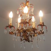 Gold metal chandelier and stamps
