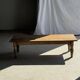 Brown Indonesian teak coffee table, with a border and cylindrical legs H40 L103.